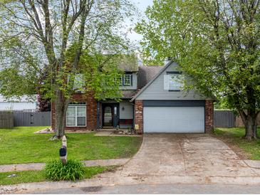 Charming two-story home with a well-manicured front lawn and mature trees at 925 Mallory Pkwy, Franklin, IN 46131