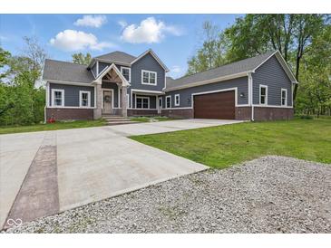 Beautiful two-story home featuring a large driveway, two-car garage, and welcoming front porch at 1490 N County Road 50 E, Danville, IN 46122