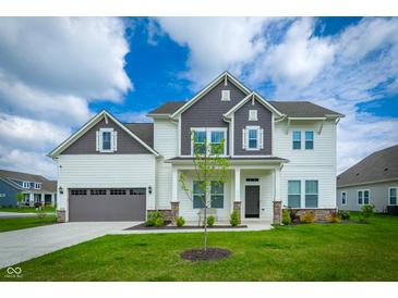 Charming two-story home with a well-manicured lawn and attached two car garage at 15792 Wiseman Dr, Fishers, IN 46040