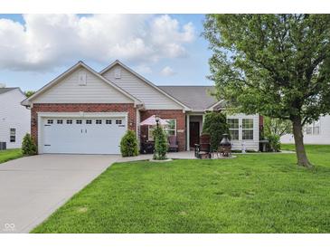 Charming brick and siding home features a well-manicured lawn and a two-car garage at 1663 Sweetgum Dr, Greenwood, IN 46143