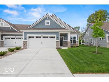 Charming single-Gathering home featuring an attached two-car garage and well-maintained landscaping at 16739 Cattle Hollow Ln, Noblesville, IN 46060