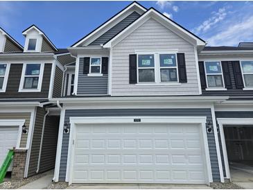 New two-story townhouse featuring gray wood and shingle siding and a two-car garage at 18763 Moray St, Westfield, IN 46074