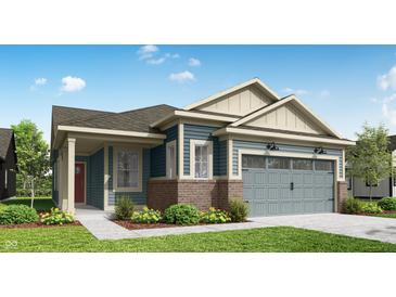 Charming exterior with blue siding, brick accents, and a two-car garage at 19473 Boulder Brook Ln, Westfield, IN 46074