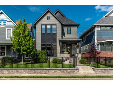 Charming two-story home with black trim, landscaped yard, and an inviting front porch at 2036 Central Ave, Indianapolis, IN 46202
