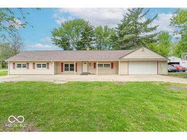 Charming single-story home with a well-manicured front lawn, a garage, and red-trimmed windows at 212 W Banta Rd, Indianapolis, IN 46217