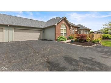 Charming single-story home features a brick facade, attached garage, and meticulously landscaped front yard at 2726 Reflection Way, Greenwood, IN 46143