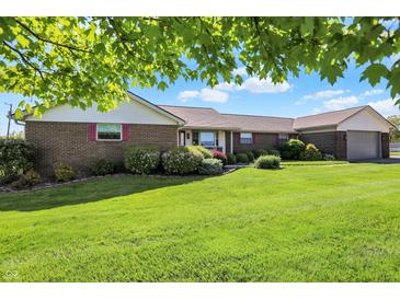Charming brick home with lush green lawn and well-manicured landscaping at 2769 S 800 W, Indianapolis, IN 46239
