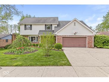 Charming two-story home with landscaped yard, brick accents, and a two-car garage at 320 Thornberry Dr, Carmel, IN 46032