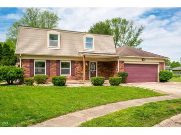 Inviting two-story brick home with tan siding and a lush green lawn, providing a welcoming curb appeal at 3505 Autumn Ct, Columbus, IN 47203