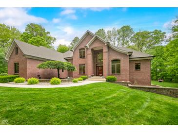 Charming brick home featuring lush landscaping and a welcoming entrance at 4128 Whitetail Woods Dr, Bargersville, IN 46106