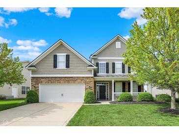 Charming two-story home with stone accents, well-maintained lawn, and inviting front porch at 4602 Amesbury Pl, Westfield, IN 46062