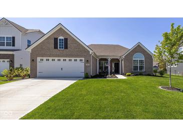 Inviting brick home with a well-manicured lawn, attached two-car garage and charming covered porch at 5375 Citadel Dr, Noblesville, IN 46062
