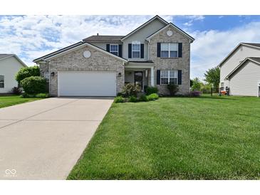 Charming two-story home featuring a brick facade, well-manicured lawn, and a two-car attached garage at 5507 Wakefield Rd, Greenwood, IN 46142