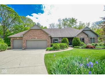 Charming brick home with a well-maintained lawn and beautiful landscaping at 5851 Beisinger Pl, Indianapolis, IN 46237