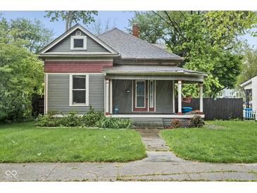 Charming craftsman-style home with a covered front porch and lush landscaping at 6159 Broadway St, Indianapolis, IN 46220