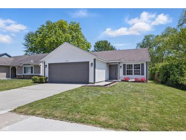 Charming single-story home with a well-manicured lawn, gray garage door, and white siding at 6613 Apollo Way, Indianapolis, IN 46278