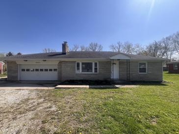 Charming single-story home featuring a brick facade and an attached garage at 6985 E County 100 S Rd, Avon, IN 46123