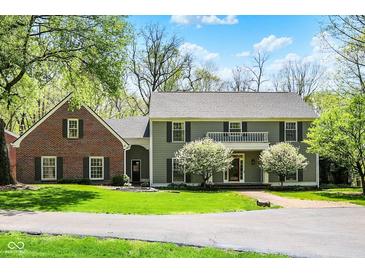 Inviting front exterior featuring a two-story home, well-manicured lawn and beautiful landscaping at 8820 Mud Creek Rd, Indianapolis, IN 46256