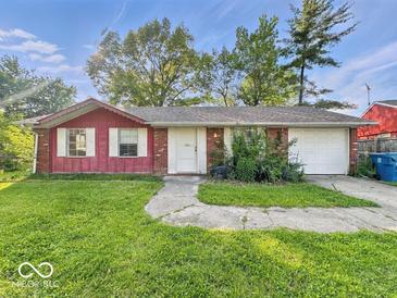 Charming single-story home featuring a two-car garage and a well-maintained front yard at 9526 Burrwood Ct, Indianapolis, IN 46235