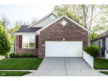 Charming single-Gathering home with a brick facade, attached two-car garage and well-manicured lawn at 1041 Lincoln Park E Dr, Greenwood, IN 46142