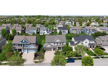An aerial view of a neighborhood showcases the well-maintained lawns and various home styles at 12722 Moonseed Dr, Carmel, IN 46032