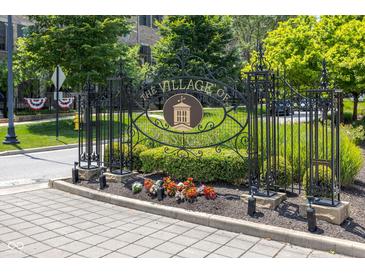 Ornate wrought iron sign welcomes you to The Village of West Clay with landscaping and brick-paved road at 12722 Moonseed Dr, Carmel, IN 46032