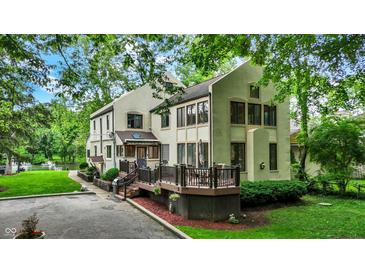 Inviting two-story home featuring a spacious deck and lush green landscaping at 1530 E 75Th St, Indianapolis, IN 46240
