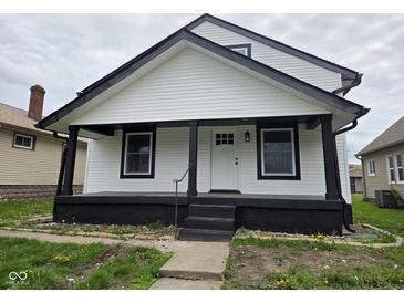 Charming home with a covered front porch, black trim, and white siding at 1545 Finley Ave, Indianapolis, IN 46203