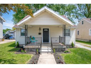 Charming home featuring a cozy front porch and a well-maintained lawn with fresh landscaping at 1912 Broadway St, Anderson, IN 46012