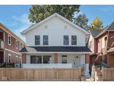 Charming two-story home with a well-maintained front yard and a classic white exterior at 2442 Guilford Ave, Indianapolis, IN 46205