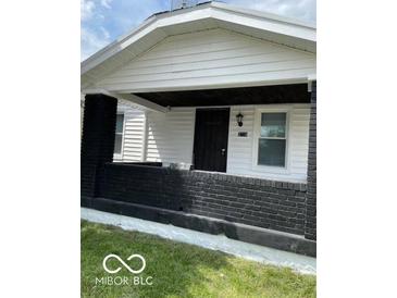 Charming home exterior featuring a quaint front porch with black brick and a freshly painted entrance at 3720 W 16Th St, Indianapolis, IN 46222
