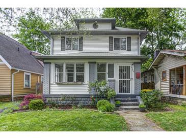 Charming two-story home with a landscaped front yard and welcoming entrance at 4244 Rookwood Ave, Indianapolis, IN 46208