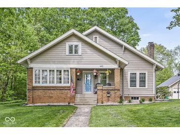 Charming home featuring a brick and siding facade, a blue door, and a welcoming front porch at 440 W Marion St, Danville, IN 46122
