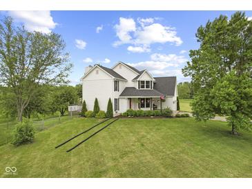 Charming two-story home featuring a manicured front lawn and a welcoming porch at 4749 Maple Grove Rd, Martinsville, IN 46151