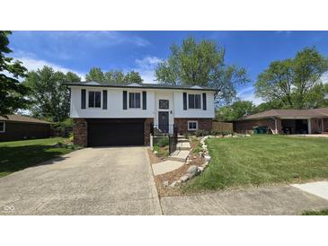 Charming split-level home featuring a well-manicured lawn and an attached two-car garage at 492 Pelenor Dr, Franklin, IN 46131