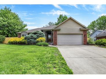 Charming single-Gathering home with manicured lawn, mature trees, and attached two car garage at 497 Pebble Way, Greenwood, IN 46142