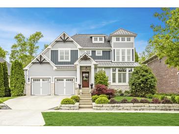 Charming two-story home with a manicured lawn, lovely landscaping, a two-car garage, and a welcoming front entrance at 6734 W Stonegate Dr, Zionsville, IN 46077