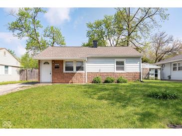 Charming single-story home featuring a well-maintained lawn and a classic brick and siding facade at 8144 E 50Th St, Indianapolis, IN 46226