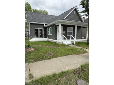 Charming home with gray siding, a new roof, and a welcoming white porch at 1327 Union St, Columbus, IN 47201