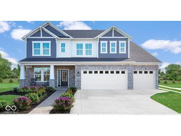 Charming two-story home with a stone facade, a two-car garage, and beautifully landscaped front yard at 175 Rock Island Rd, Westfield, IN 46074