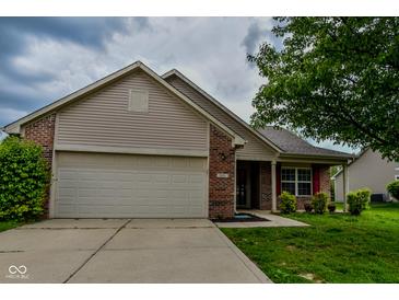 Charming two-story home with a brick facade, siding, attached garage, and a well-manicured front lawn at 2416 Foxtail Dr, Plainfield, IN 46168