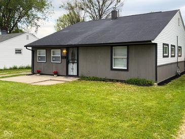 Charming one-story home featuring manicured lawn, gray siding, and black trim at 2435 Asbury St, Indianapolis, IN 46203