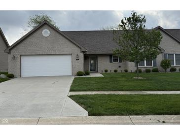 Charming single-story home featuring a well-manicured lawn, brick facade, and a two-car garage at 2635 Red Admiral Ln, Lebanon, IN 46052