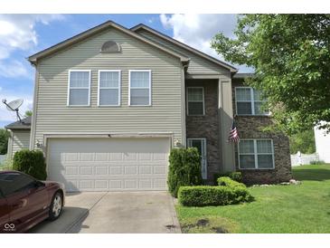 Two-story home featuring vinyl siding, brick accents, manicured landscaping, and an attached two car garage at , Greenwood, IN 46143