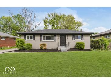 Exterior shot of renovated house including new landscaping and expansive front lawn at 4337 N Audubon Rd, Indianapolis, IN 46226