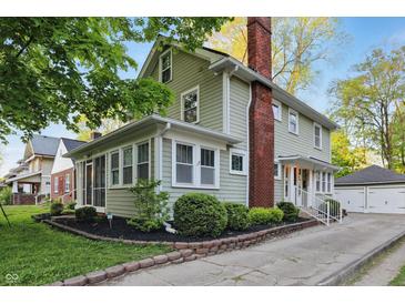 Charming two-story home boasts a brick chimney and well-maintained landscaping at 4447 N College Ave, Indianapolis, IN 46205