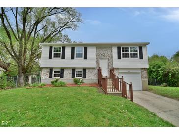 Charming split-level home with a well-manicured lawn, brick accents, and a cozy front porch at 4527 Peachwood Ct, Indianapolis, IN 46235