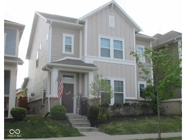 Charming two-story home with inviting front porch and well-manicured lawn exudes curb appeal at 5755 Buskirk Dr, Indianapolis, IN 46216