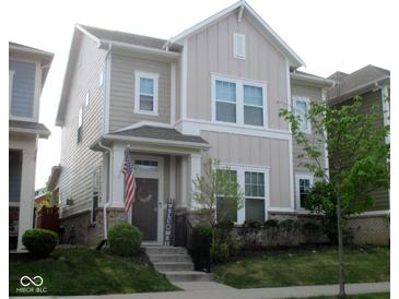 Charming two-story home with neutral siding, a welcoming porch, and a well-manicured front lawn at 5755 Buskirk Dr, Indianapolis, IN 46216