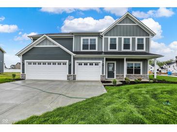 Beautiful two-story home featuring a three-car garage, stone accents, and well-manicured lawn at 7132 Sterling Way, Brownsburg, IN 46112